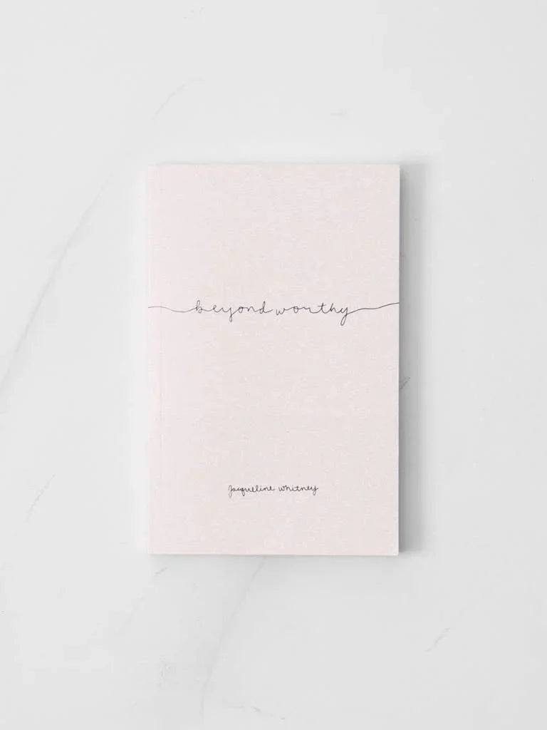 Minimalist pale pink book titled beyond worthy by Jacqueline Whitney on white surface. Come see us at Awaken, Franklin, Tennessee
