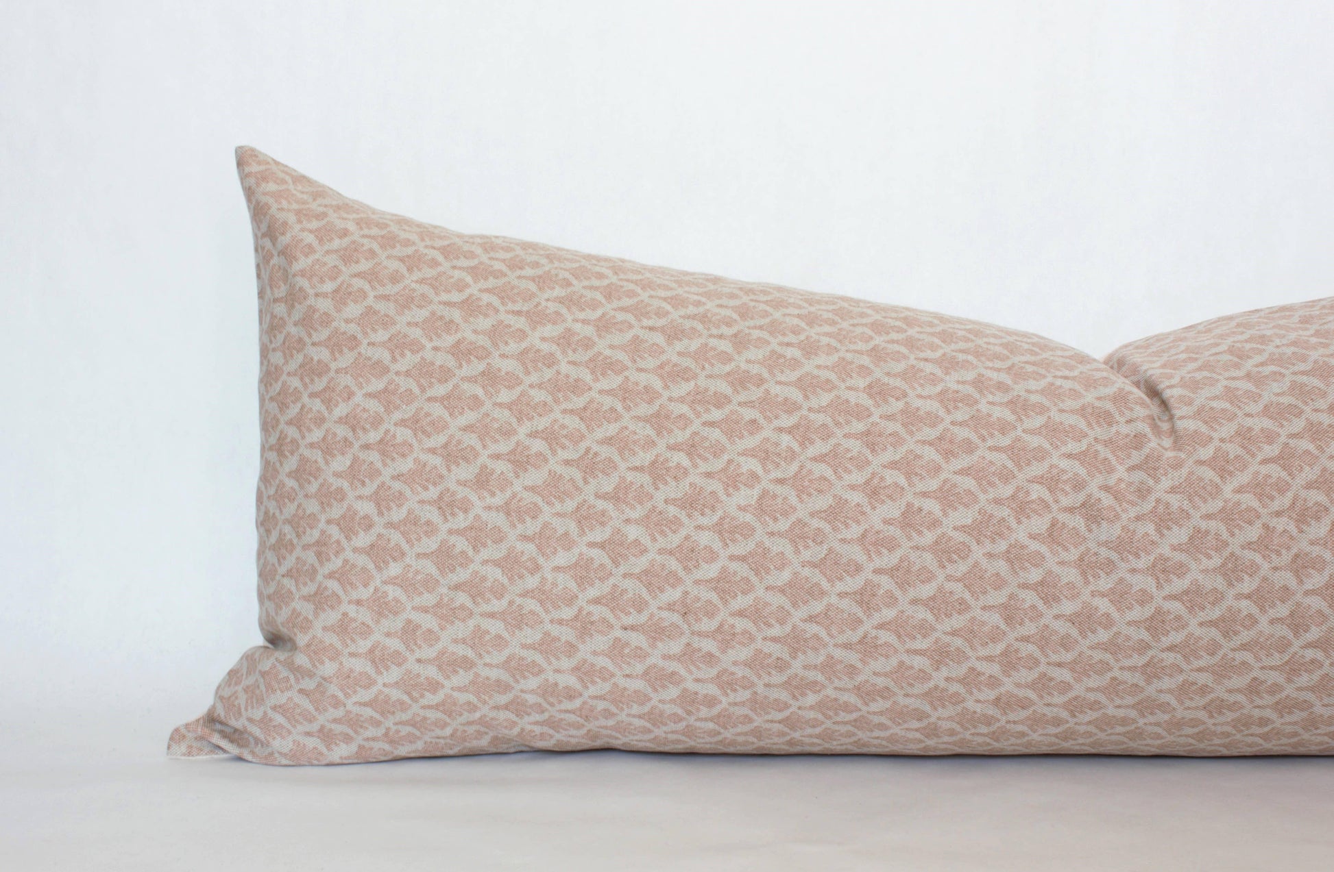 Rectangular beige pillow with subtle geometric pattern on white background, Come see us at Awaken, Franklin, Tennessee