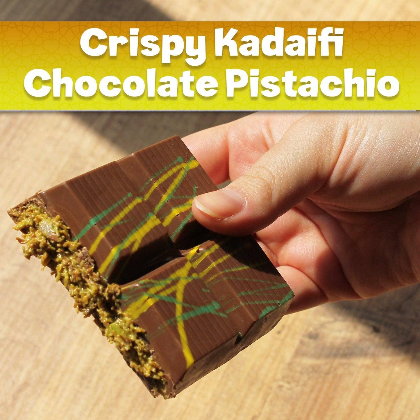 Hand holding crispy kadaifi chocolate pistachio bar with colorful drizzle, Come see us at Awaken, Franklin, Tennessee