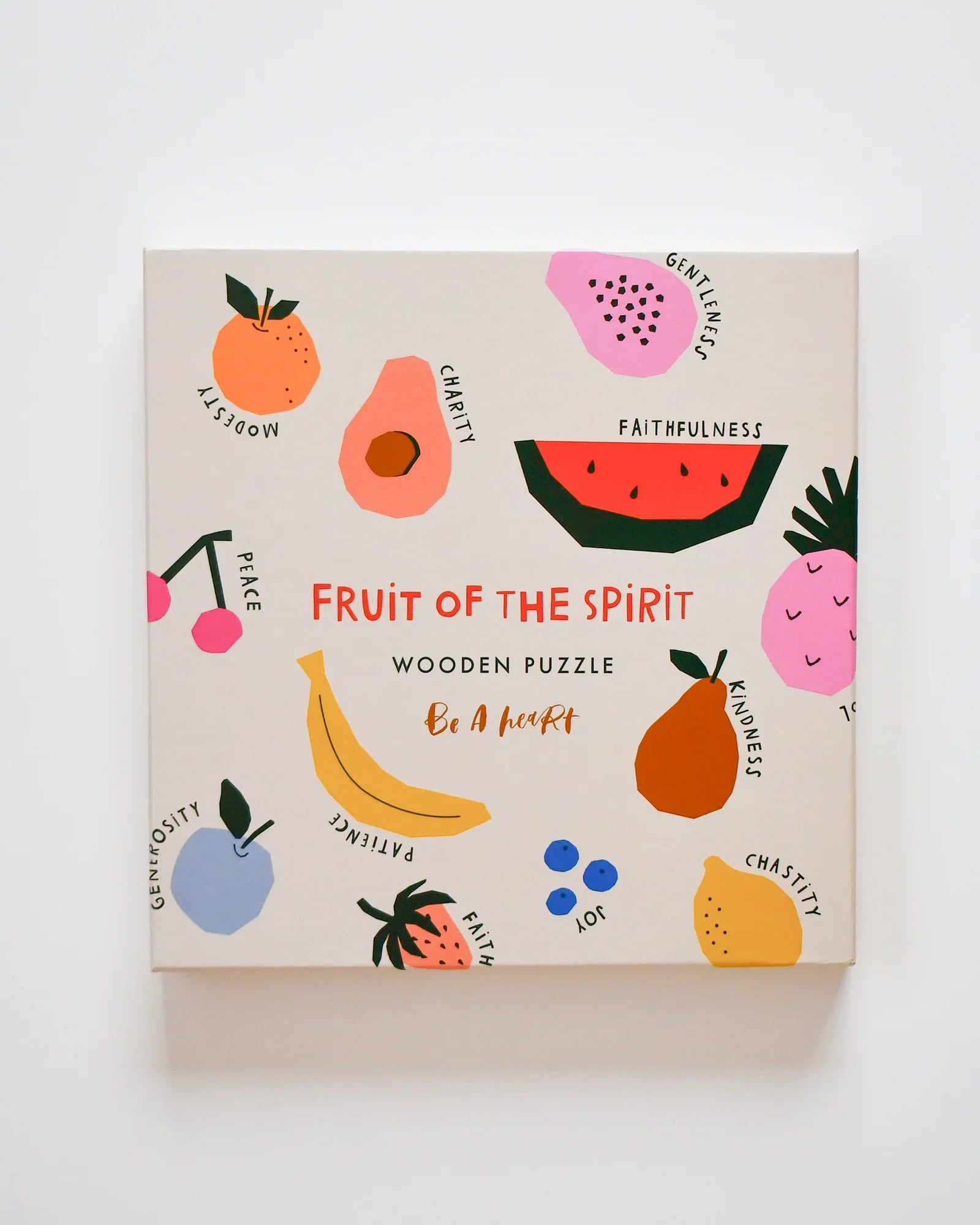 Fruit of the Spirit wooden puzzle box with colorful fruit illustrations and virtues labeled. Come see us at Awaken, Franklin, Tennessee