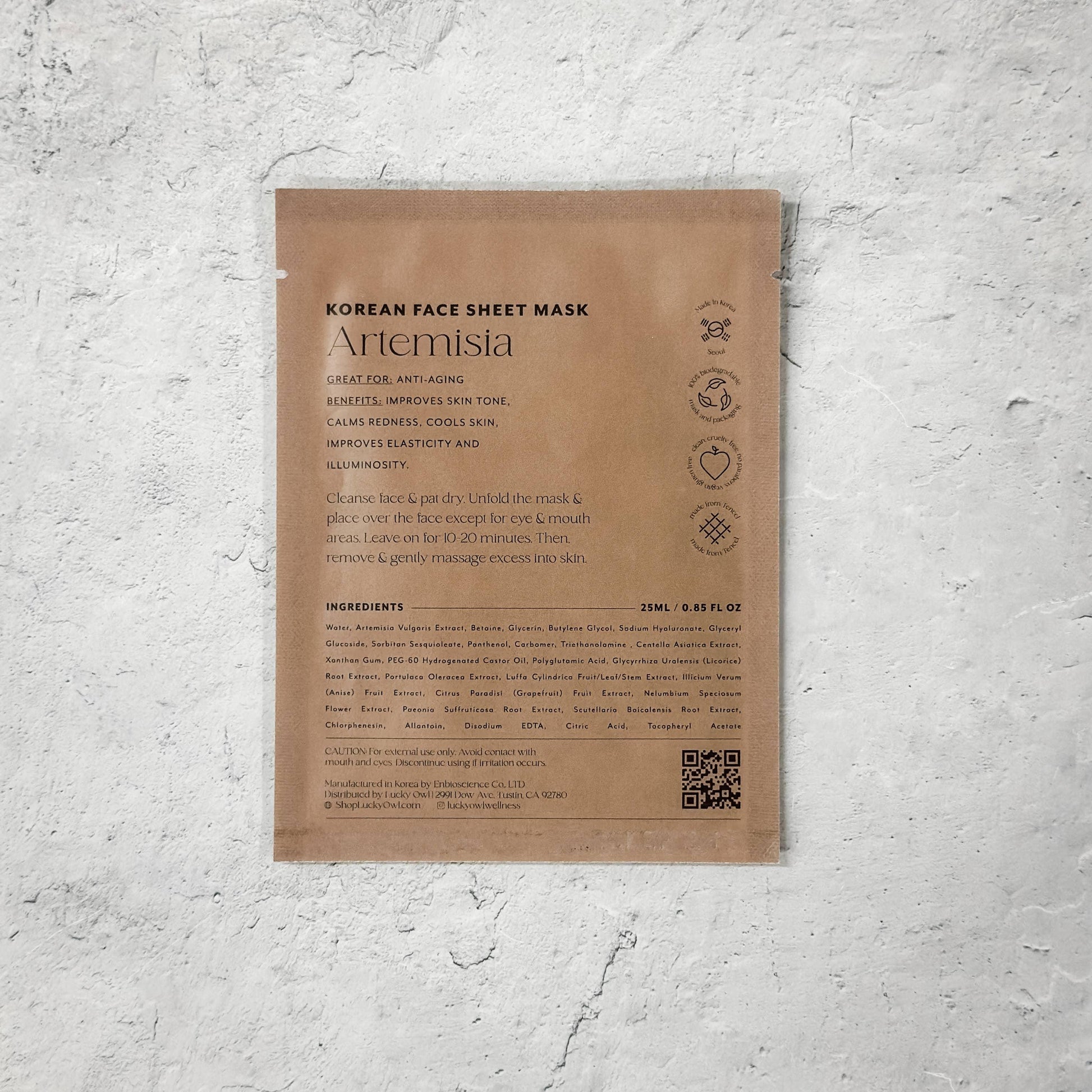 Korean face sheet mask Artemisia brown package against white wall; Come see us at Awaken, Franklin, Tennessee.