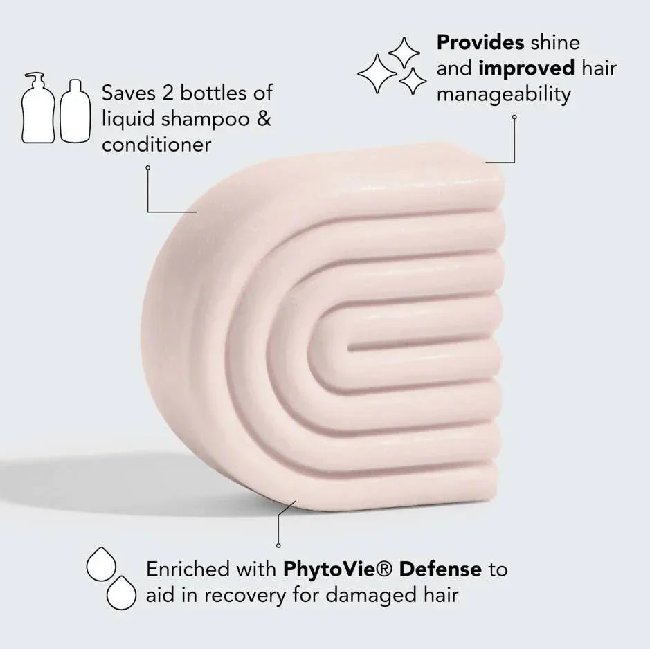 Light pink solid shampoo bar highlighting hair benefits like saving 2 bottles, shine, and PhytoVie Defense. Come see us at Awaken, Franklin, Tennessee