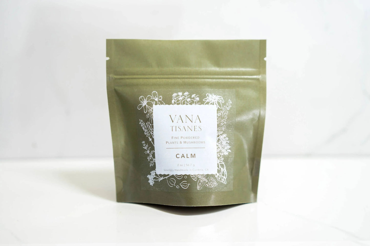 Vana Tisanes Calm herbal powder pouch with plant illustrations, on white surface. Come see us at Awaken, Franklin, Tennessee