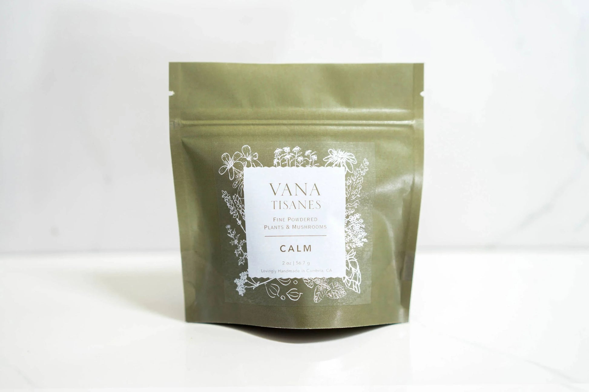 Vana Tisanes Calm herbal powder pouch with plant illustrations, on white surface. Come see us at Awaken, Franklin, Tennessee