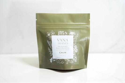 Vana Tisanes Calm herbal powder pouch with plant illustrations, on white surface. Come see us at Awaken, Franklin, Tennessee