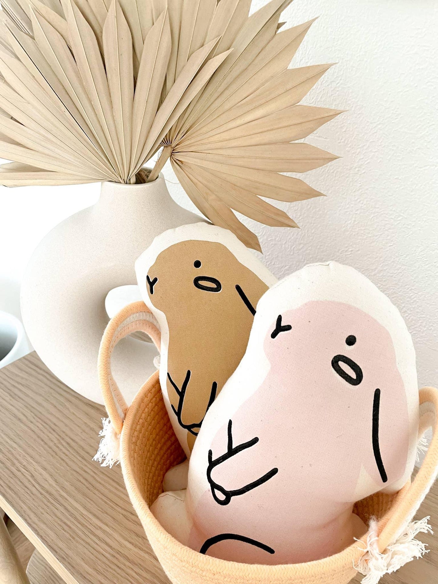 Minimalist plush toys in basket, dried palm leaves decor, Come see us at Awaken, Franklin, Tennessee