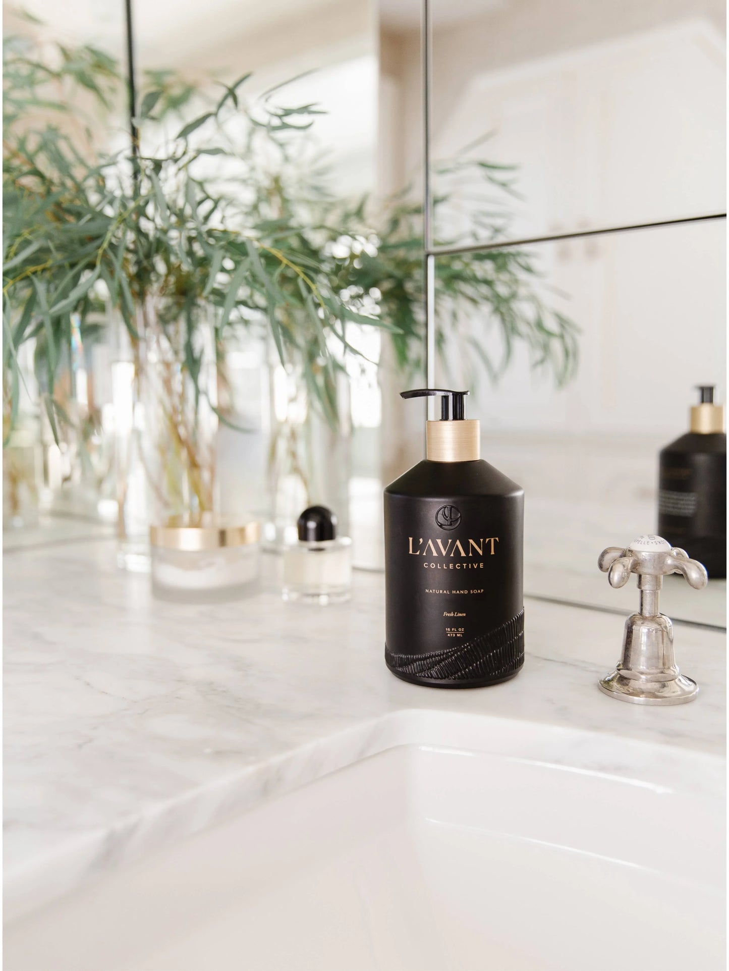 L'AVANT Collective hand soap on marble bathroom counter with greenery, Come see us at Awaken, Franklin, Tennessee