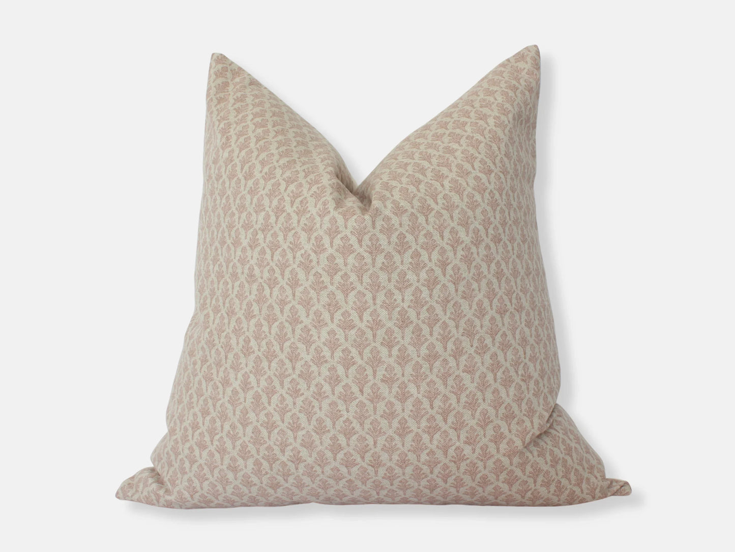 Beige decorative throw pillow with subtle floral pattern on white background. Come see us at Awaken, Franklin, Tennessee
