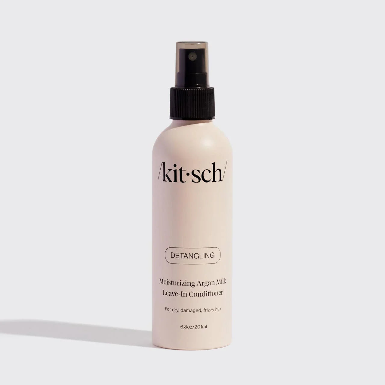 Kitsch moisturizing argan milk detangling leave-in conditioner bottle on white background. Come see us at Awaken, Franklin, Tennessee