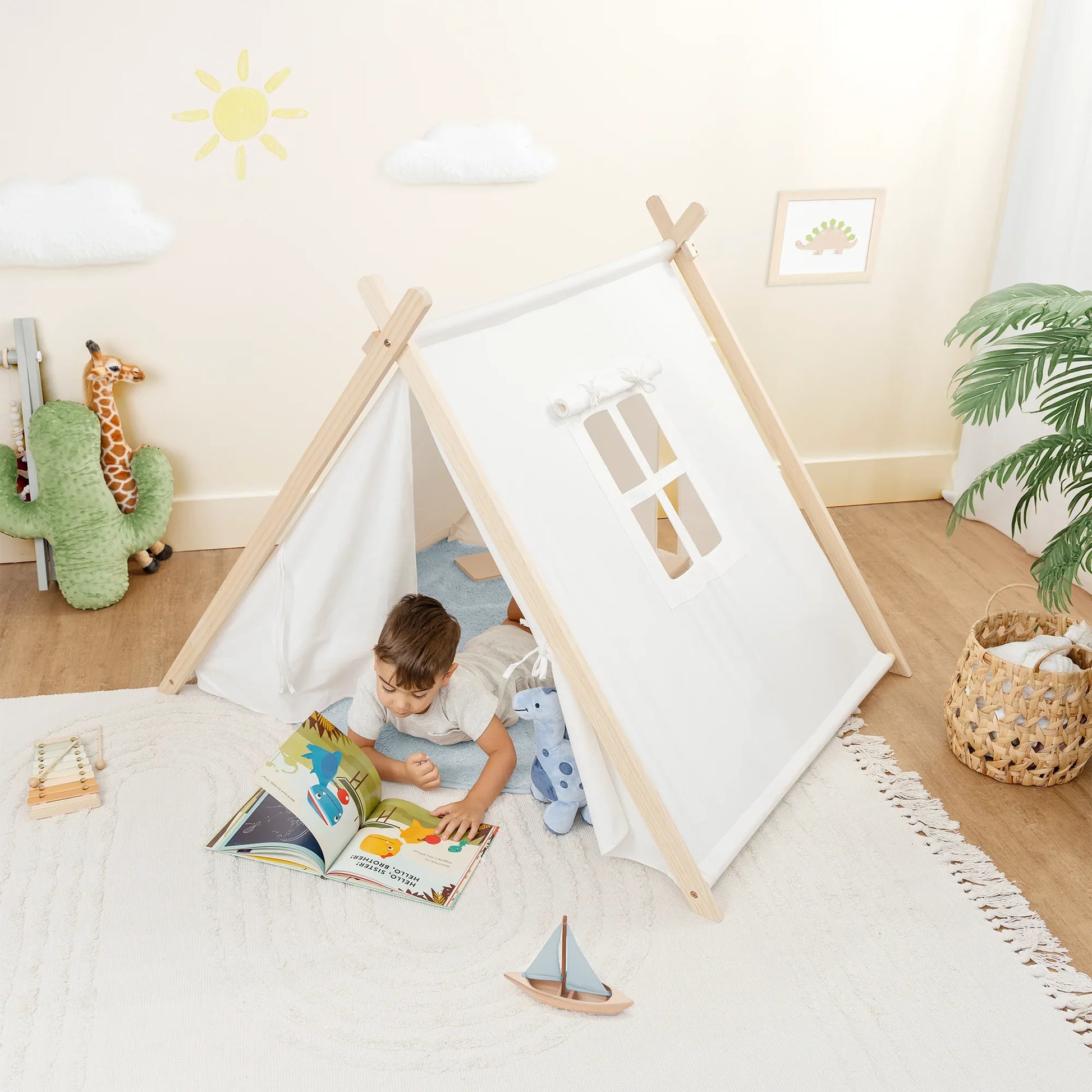 Child reading in a white play tent with toys in cozy kids room, Come see us at Awaken, Franklin, Tennessee