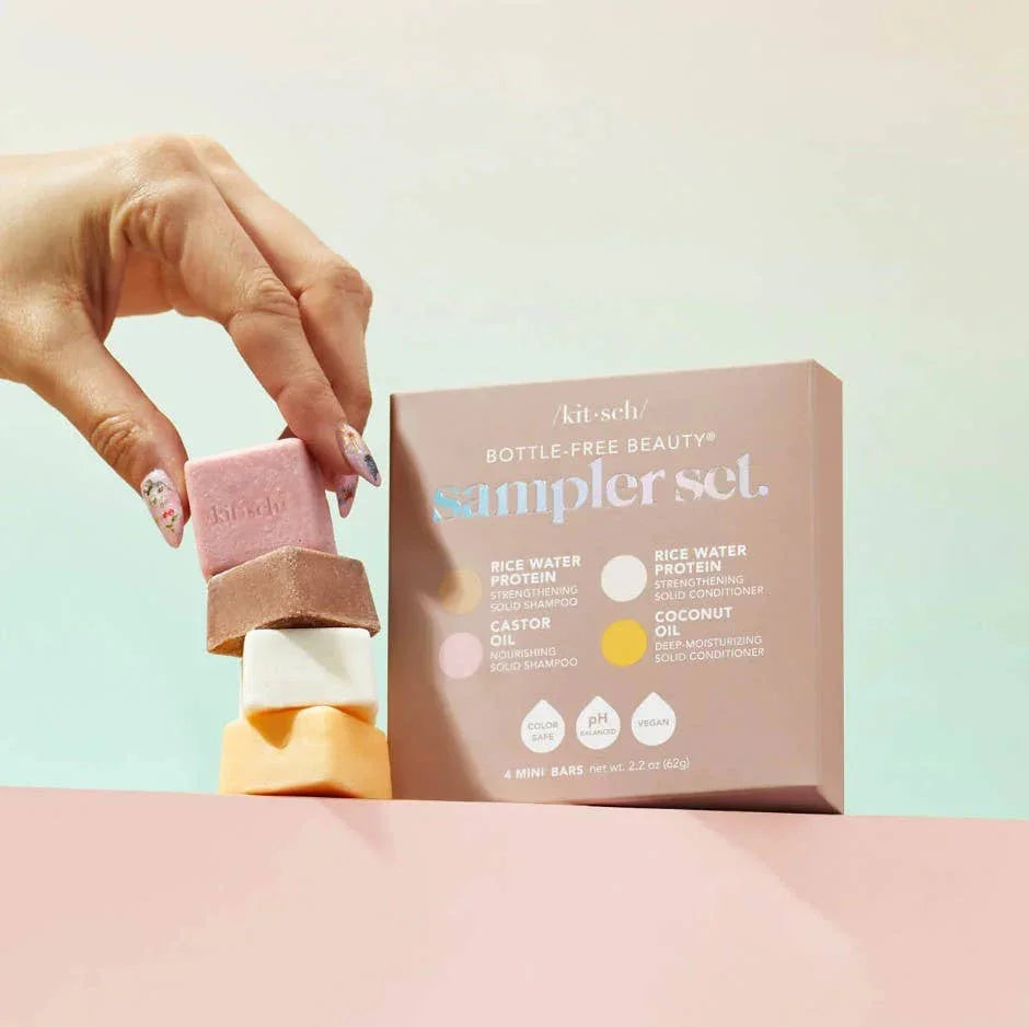 Hand stacking Kitsch bottle-free beauty solid shampoo and conditioner bars from sampler set with pastel packaging Come see us at Awaken, Franklin, Tennessee