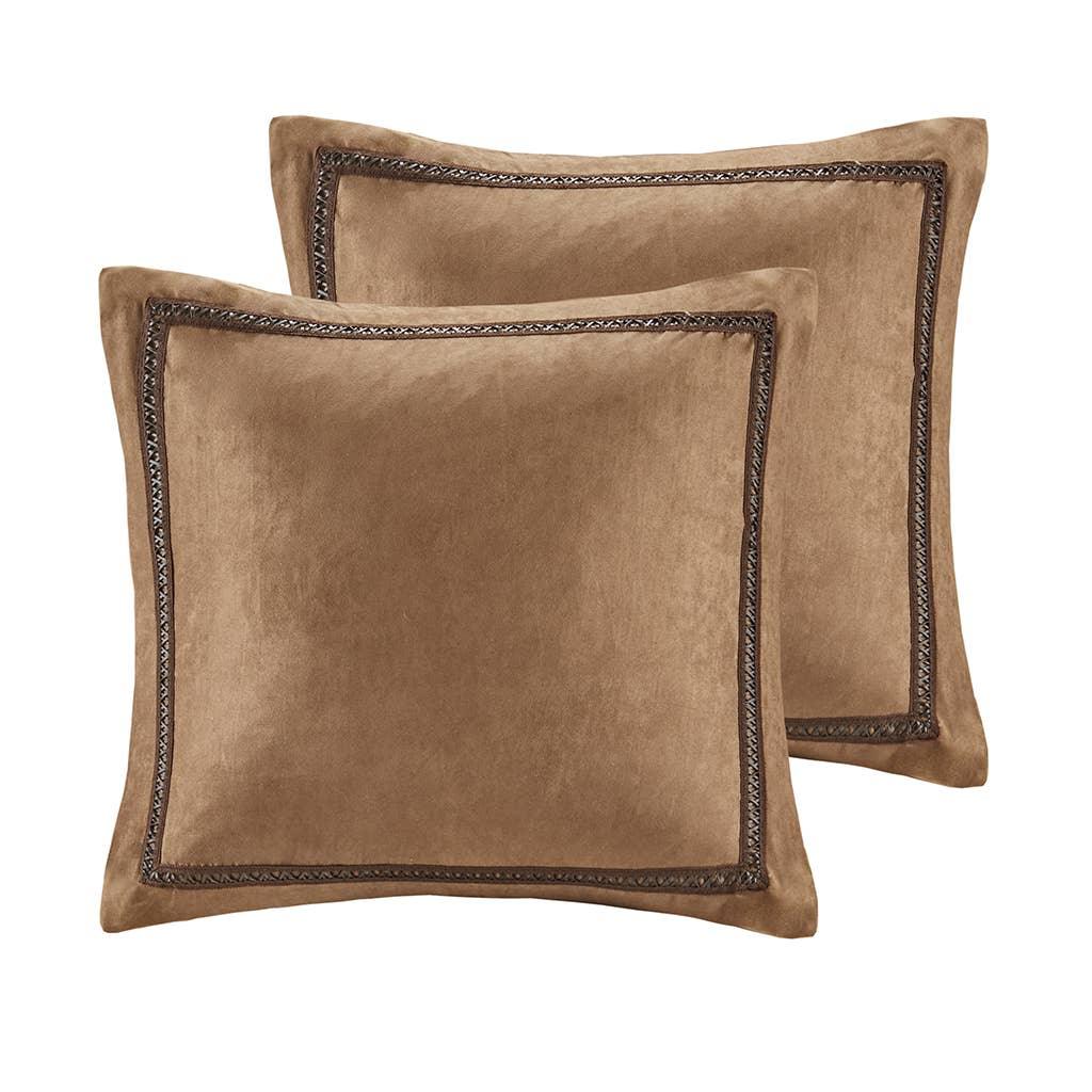 Set of two brown suede decorative throw pillows with stitched border detail. Come see us at Awaken, Franklin, Tennessee