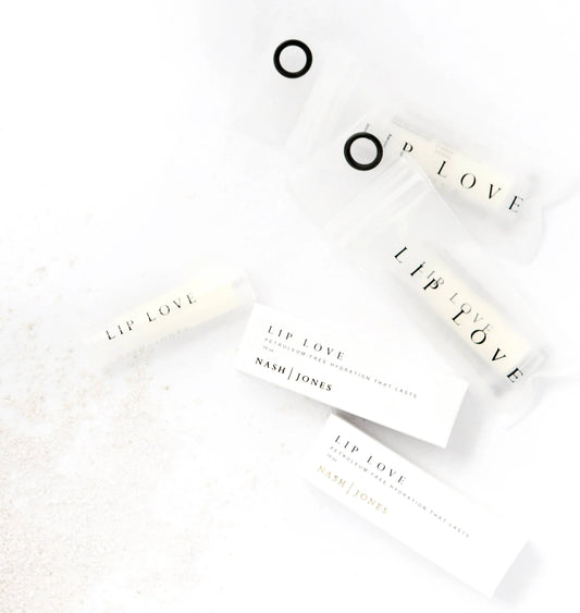 Lip Love petroleum-free lip balms and packaging by Nash Jones displayed on white surface. Come see us at Awaken, Franklin, Tennessee