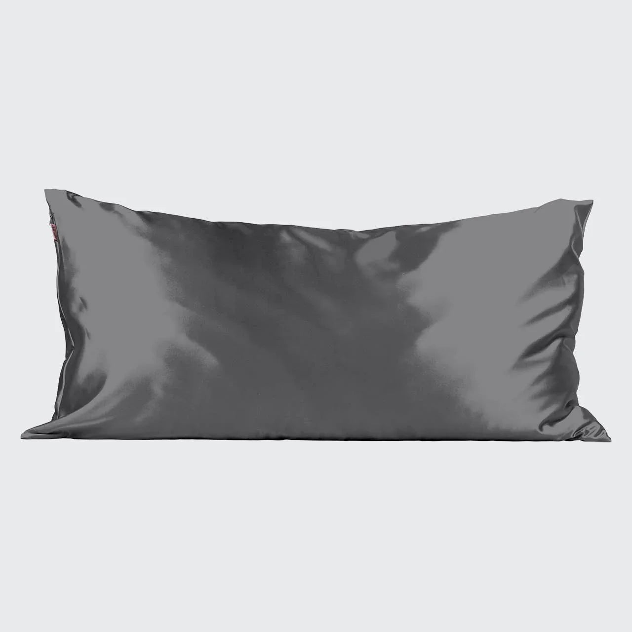 Long gray satin pillow with smooth texture on light background. Come see us at Awaken, Franklin, Tennessee