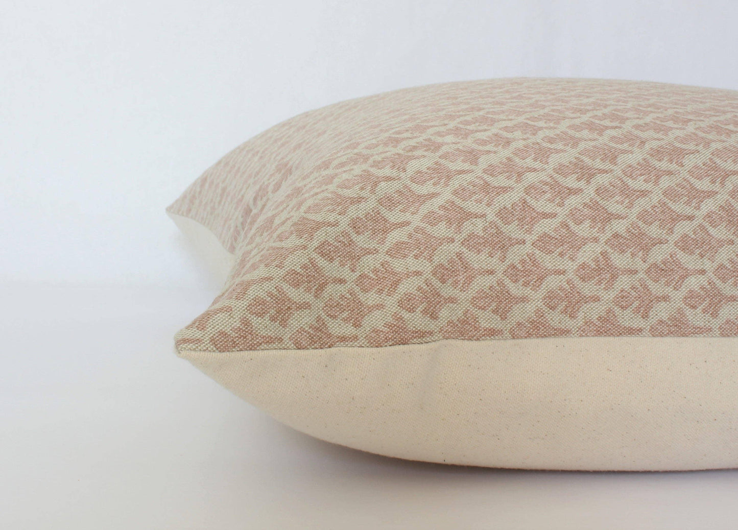 Decorative beige pillow with textured geometric pattern on white background Come see us at Awaken, Franklin, Tennessee