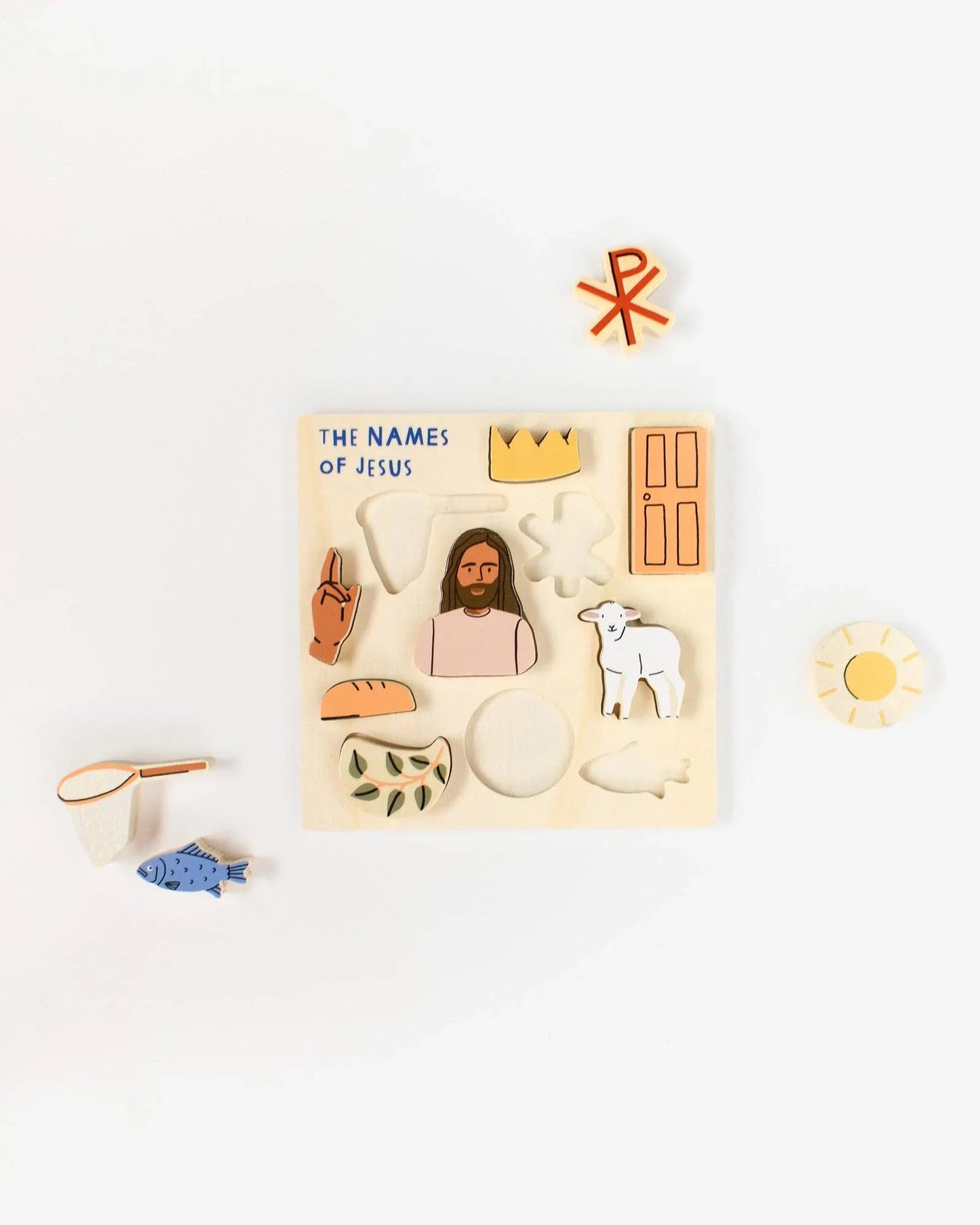 Wooden puzzle with 'The Names of Jesus', illustrated religious symbols, and Jesus figure; Come see us at Awaken, Franklin, Tennessee.