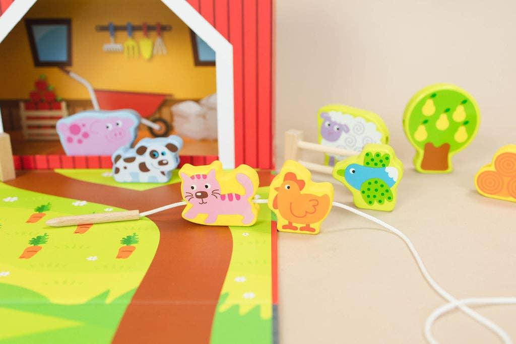 Colorful wooden farm animal toys including cat, chicken, bird in a farm playset. Come see us at Awaken, Franklin, Tennessee