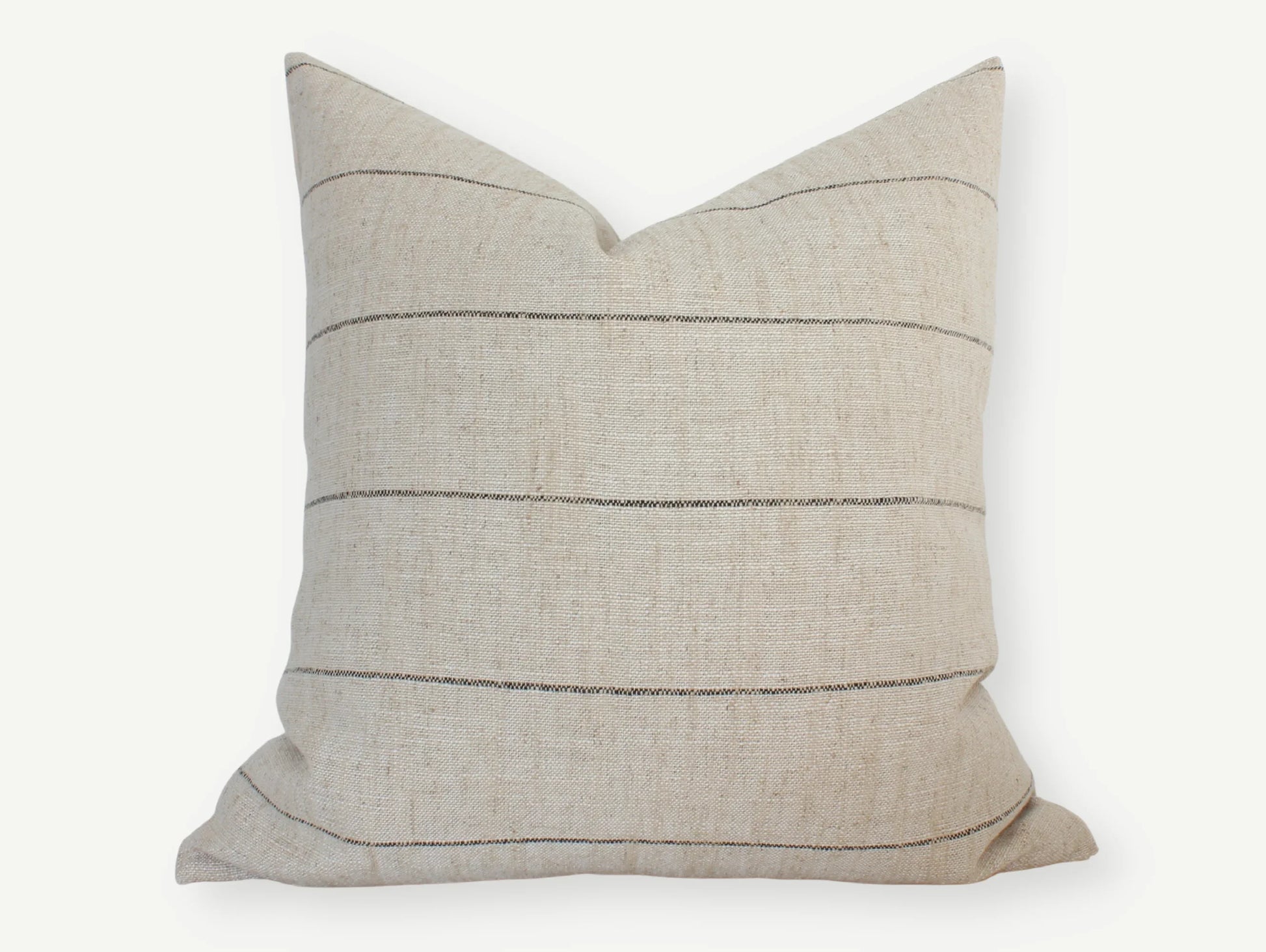 Beige textured throw pillow with thin horizontal stripes on white background. Come see us at Awaken, Franklin, Tennessee