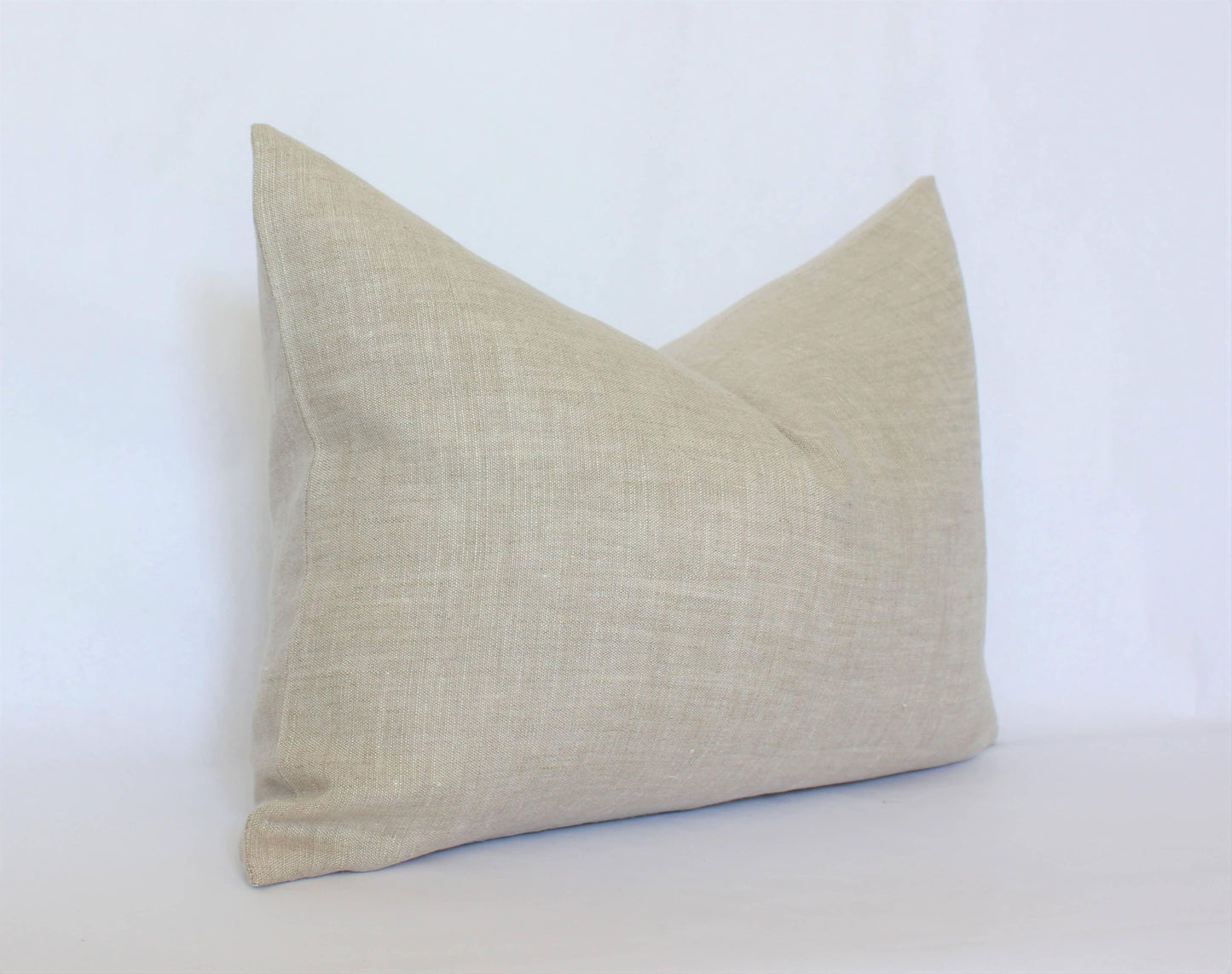 Beige linen rectangular pillow on white background. Come see us at Awaken, Franklin, Tennessee