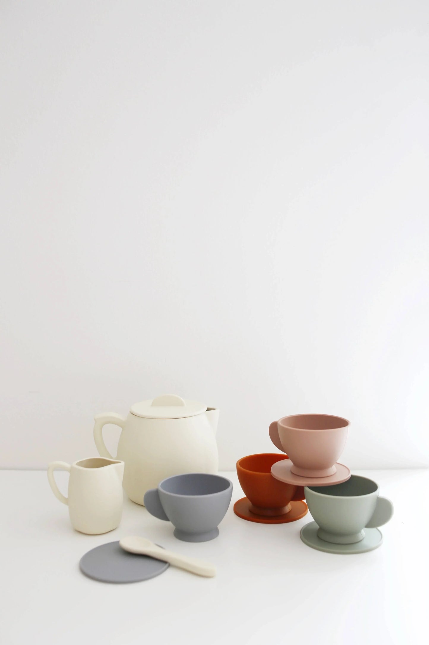 Minimalist ceramic teapot and pastel cups on white table, Come see us at Awaken, Franklin, Tennessee