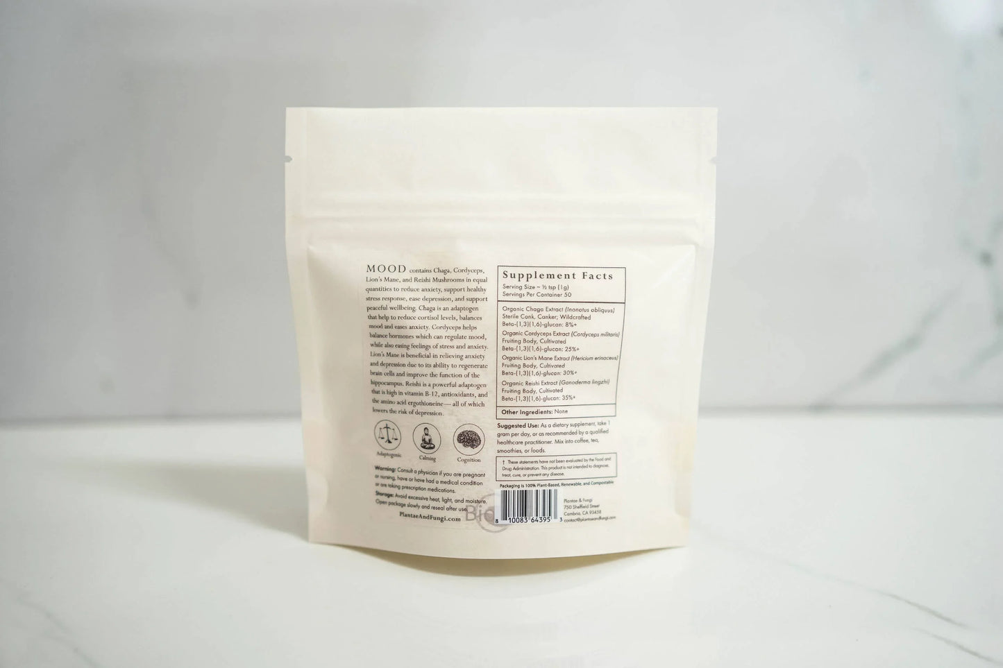 Back of white supplement pouch labeled MOOD with ingredients and supplement facts on marble surface. Come see us at Awaken, Franklin, Tennessee