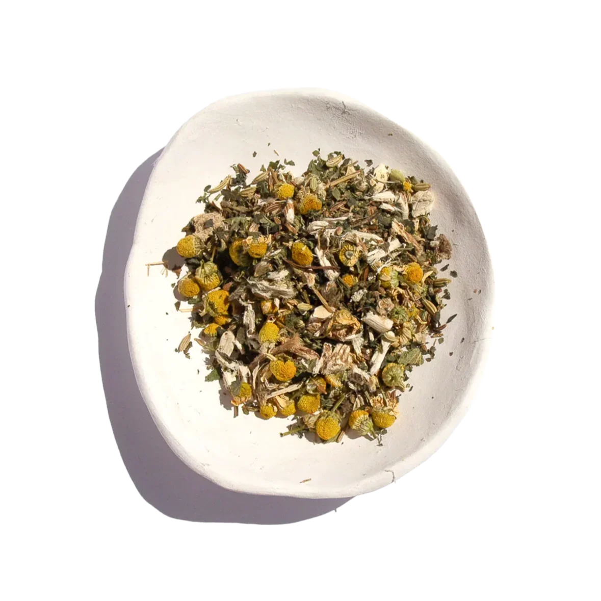 Herbal tea blend with chamomile and dried herbs in white bowl, Come see us at Awaken, Franklin, Tennessee