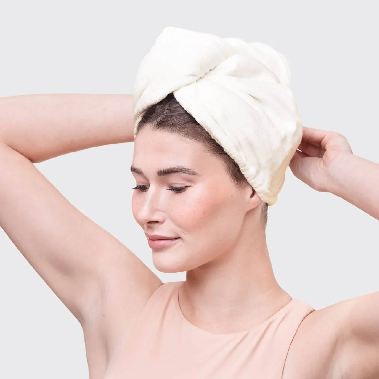 Woman with towel turban on head, light background. Come see us at Awaken, Franklin, Tennessee