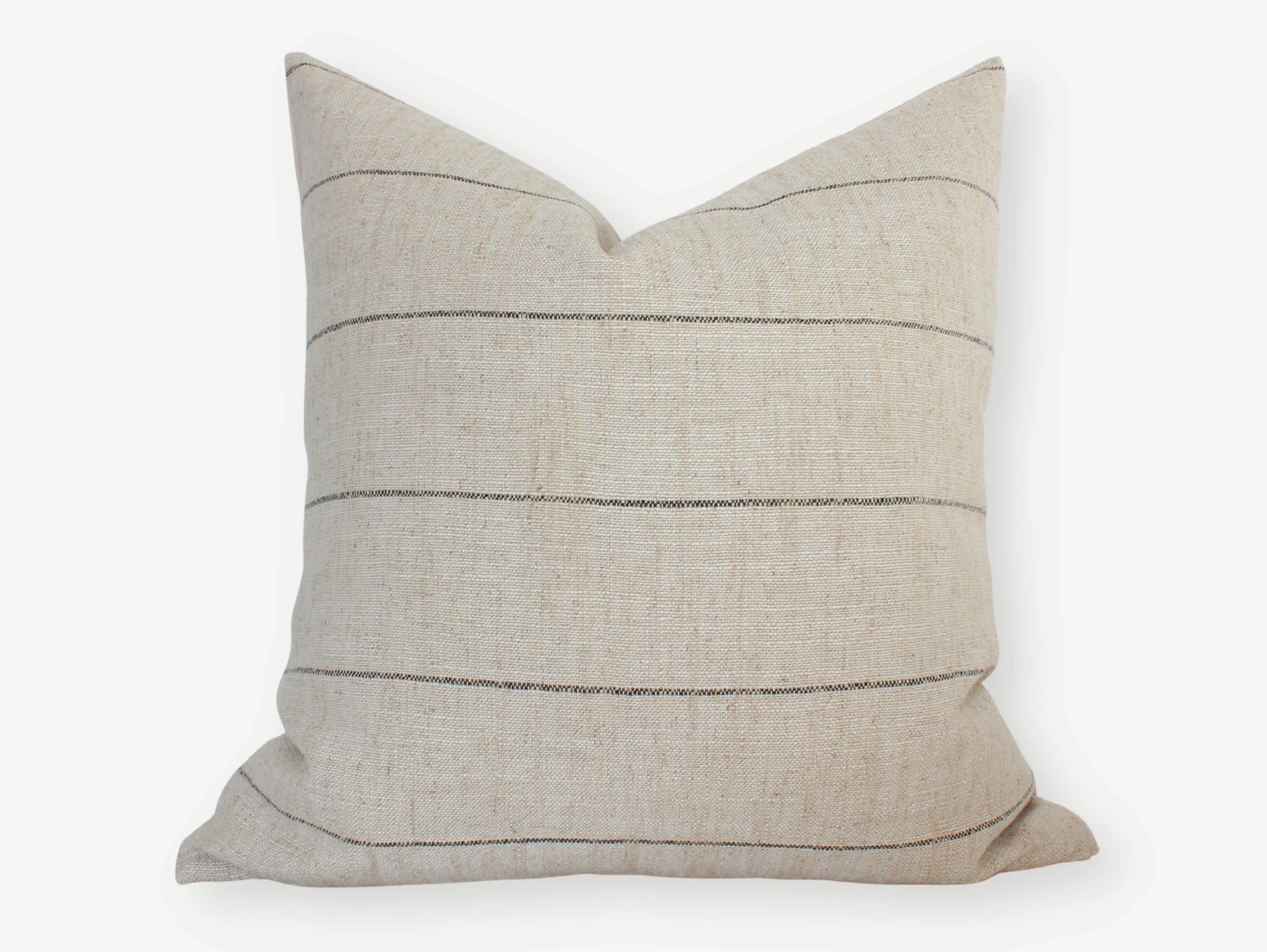 Beige lumbar pillow with thin black horizontal stripes on white background. Come see us at Awaken, Franklin, Tennessee