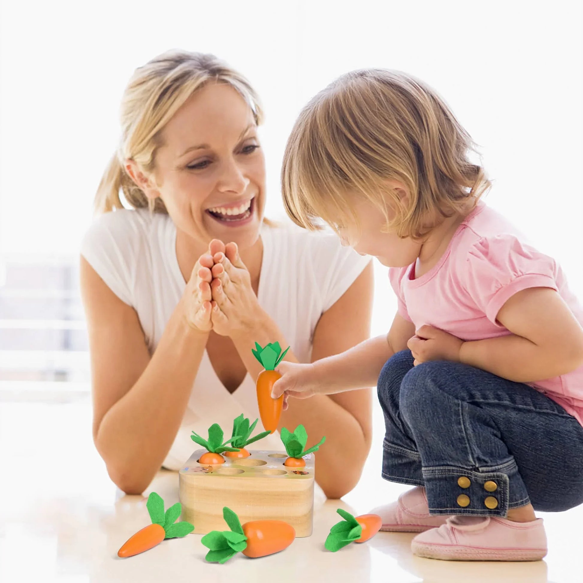 Mother and child playing with wooden carrot toy. Come see us at Awaken, Franklin, Tennessee.
