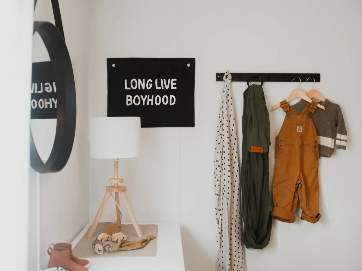 Kids room decor with 'Long Live Boyhood' sign, lamp, overalls, and scarf, Come see us at Awaken, Franklin, Tennessee