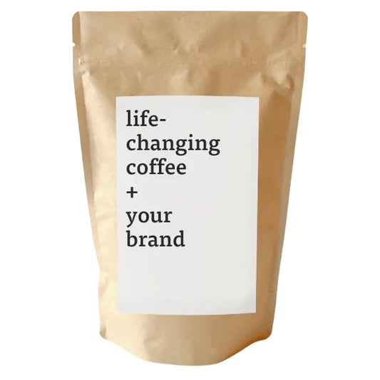 Brown coffee bag with 'life-changing coffee + your brand' label. Come see us at Awaken, Franklin, Tennessee.