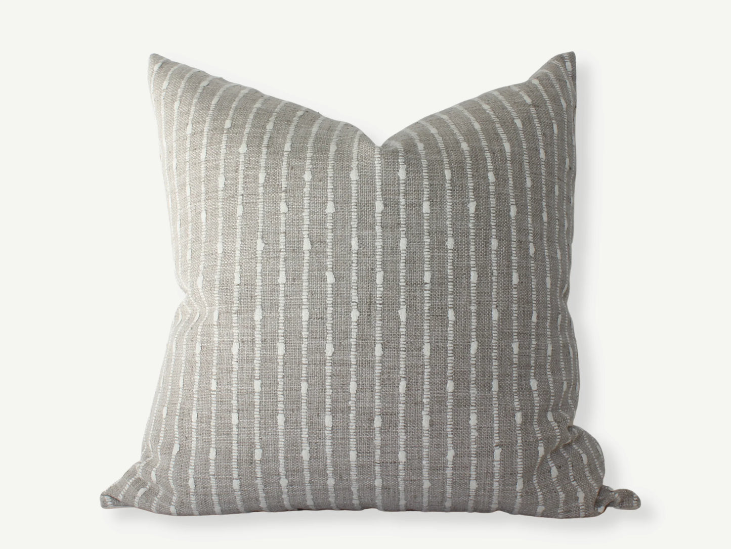 Gray decorative pillow with white vertical dotted stripes on neutral background, Come see us at Awaken, Franklin, Tennessee