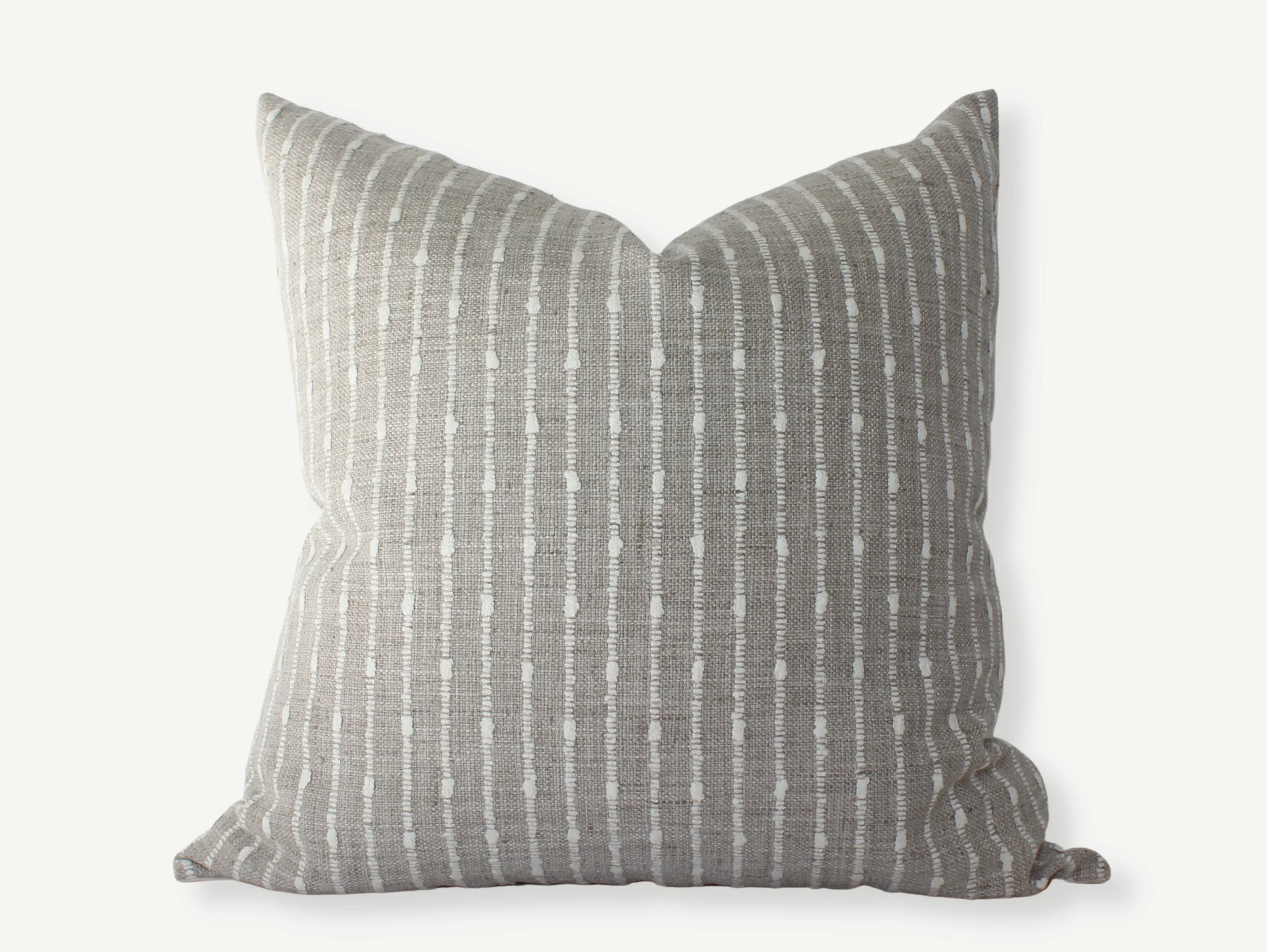 Gray decorative pillow with white vertical dotted stripes on neutral background, Come see us at Awaken, Franklin, Tennessee