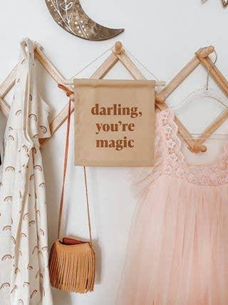 Pastel kids' room decor with sign 'darling, you're magic.' Come see us at Awaken, Franklin, Tennessee.