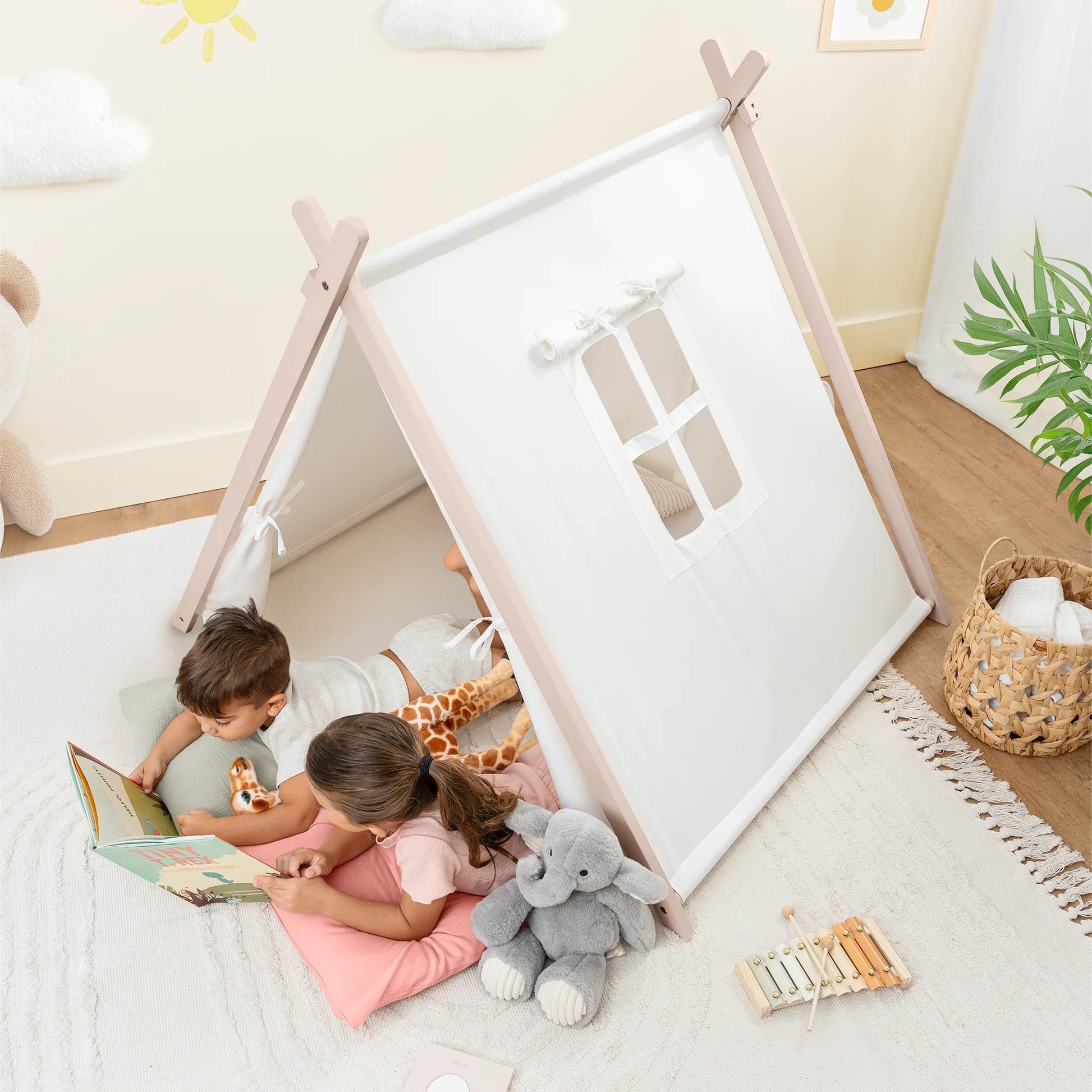 Kids reading in play tent with stuffed animals, cozy nursery decor, Come see us at Awaken, Franklin, Tennessee