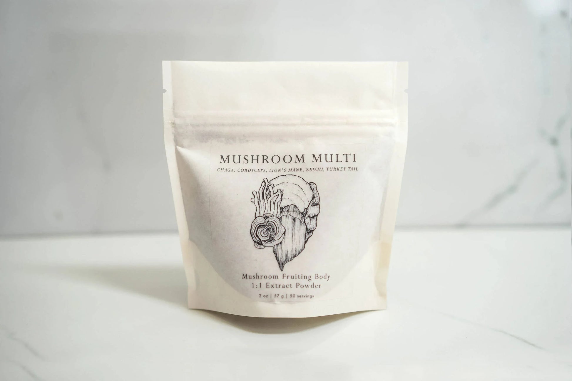 Mushroom Multi extract powder package on white marble surface with sketch art, Come see us at Awaken, Franklin, Tennessee
