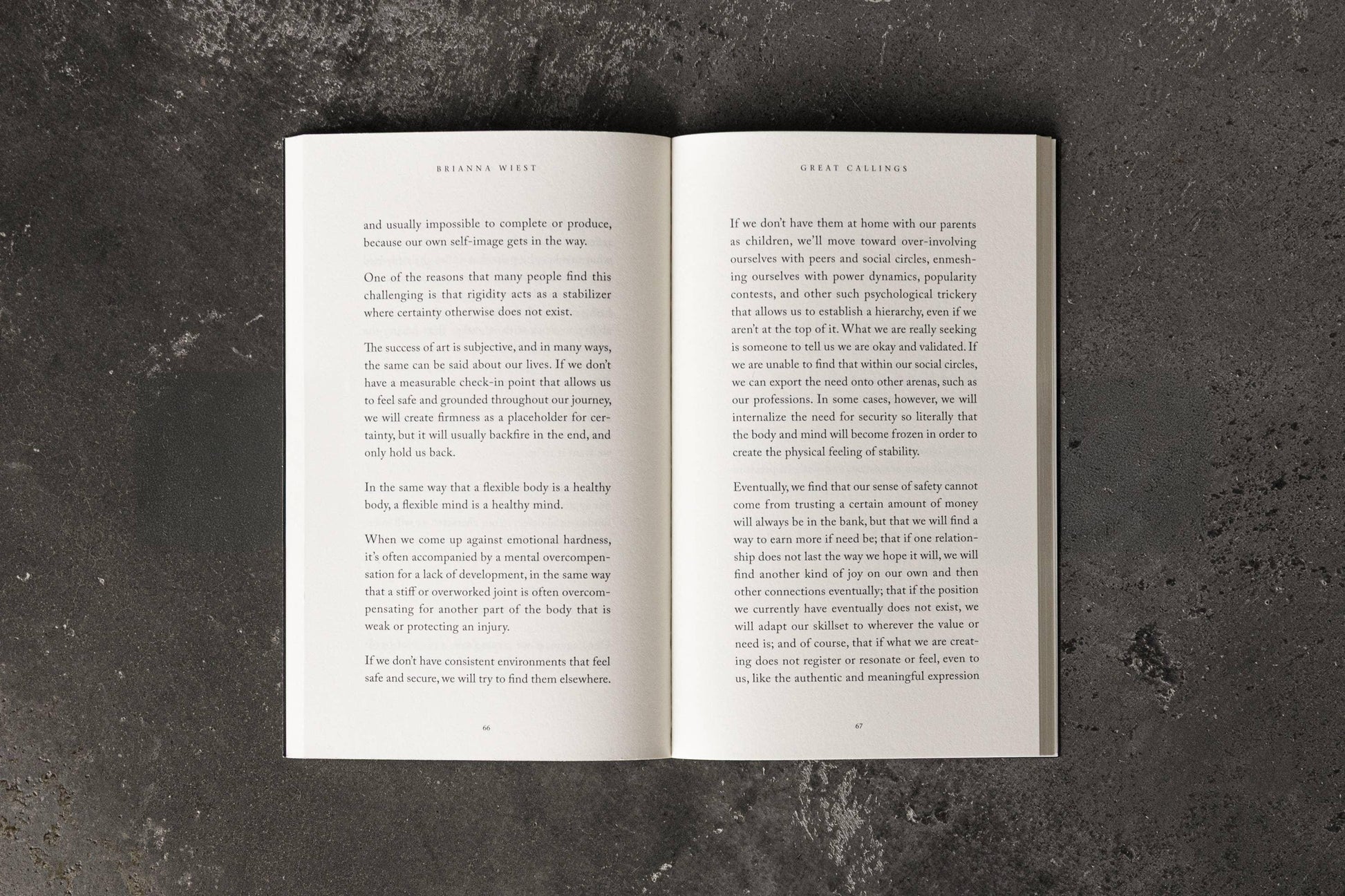 Open book on concrete surface showing text by Brianna Wiest titled Great Callings. Come see us at Awaken, Franklin, Tennessee