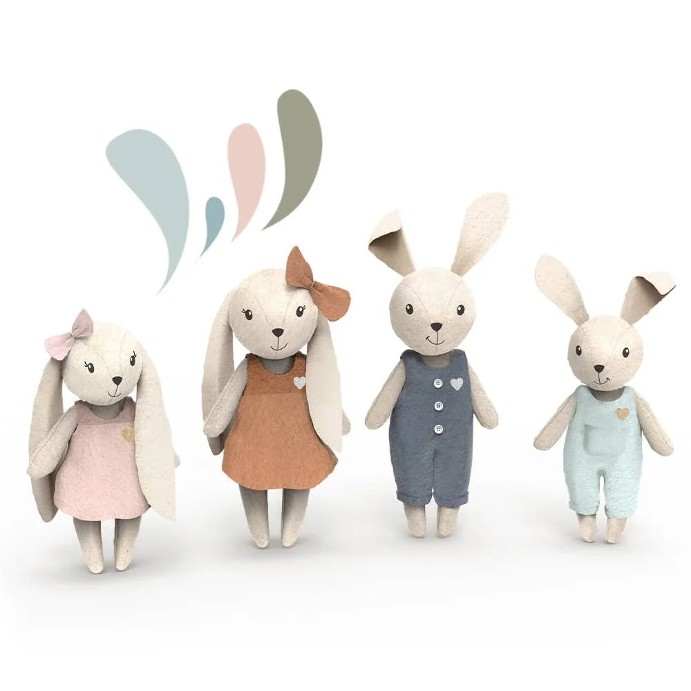Four soft fabric bunny dolls in pastel dresses and overalls, whimsical design, white background. Come see us at Awaken, Franklin, Tennessee