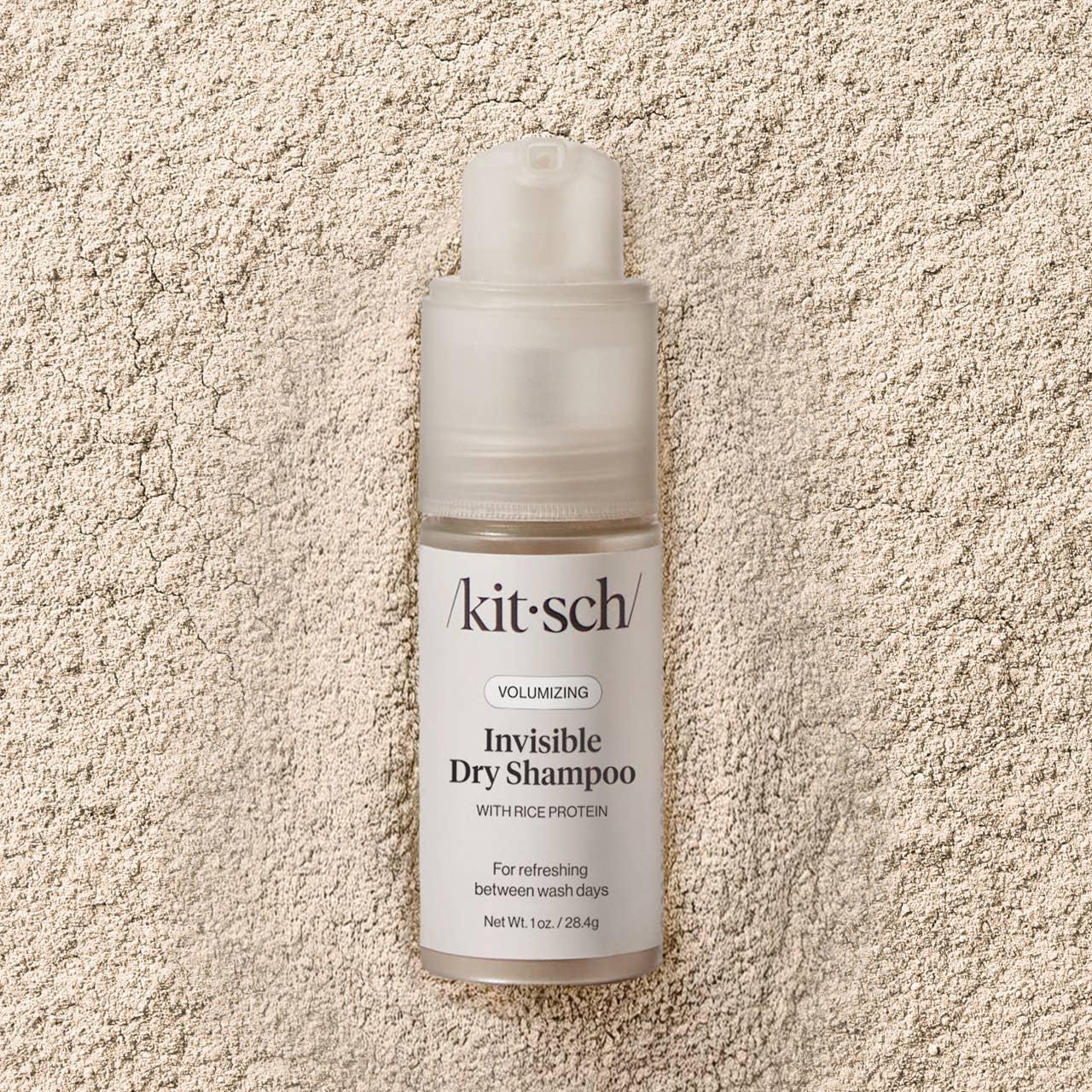 Kitsch Volumizing Invisible Dry Shampoo bottle on textured powder background, Come see us at Awaken, Franklin, Tennessee