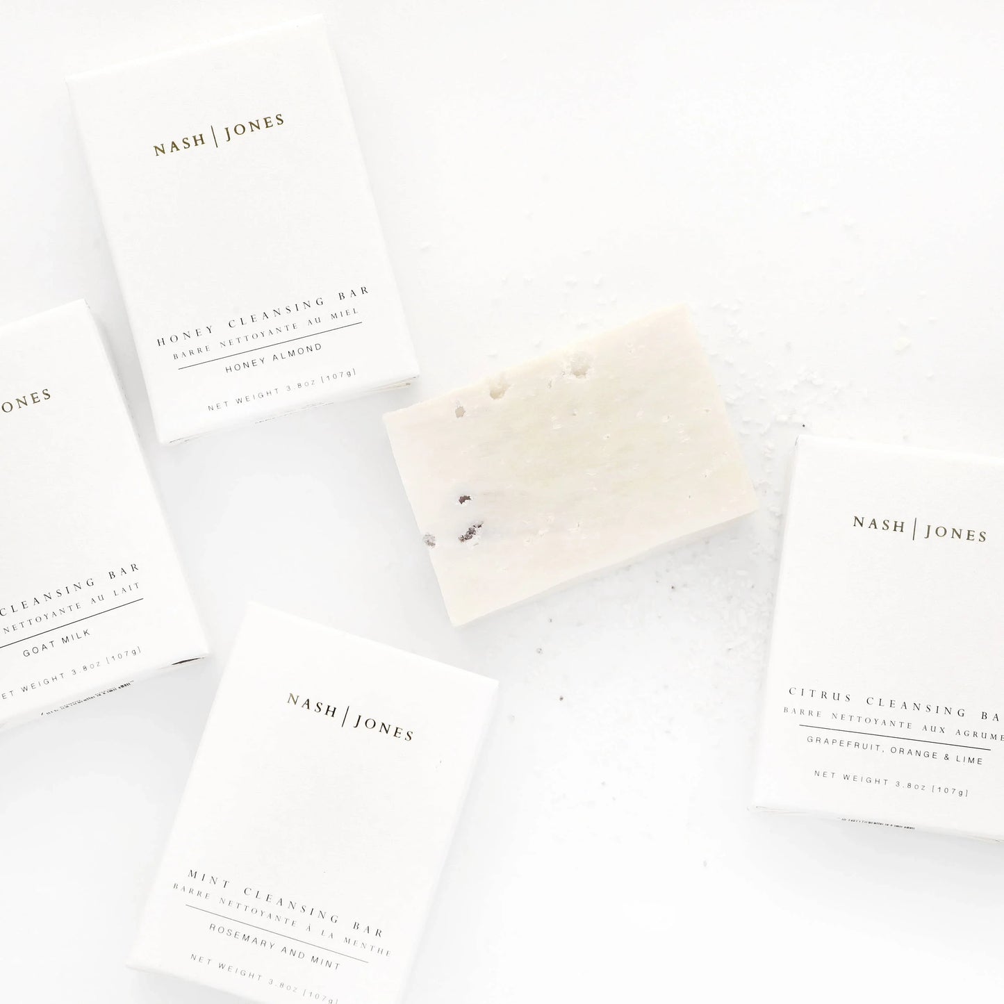 Nash Jones cleansing bars in minimalist white packaging with one bar unwrapped, clean aesthetic, Come see us at Awaken, Franklin, Tennessee