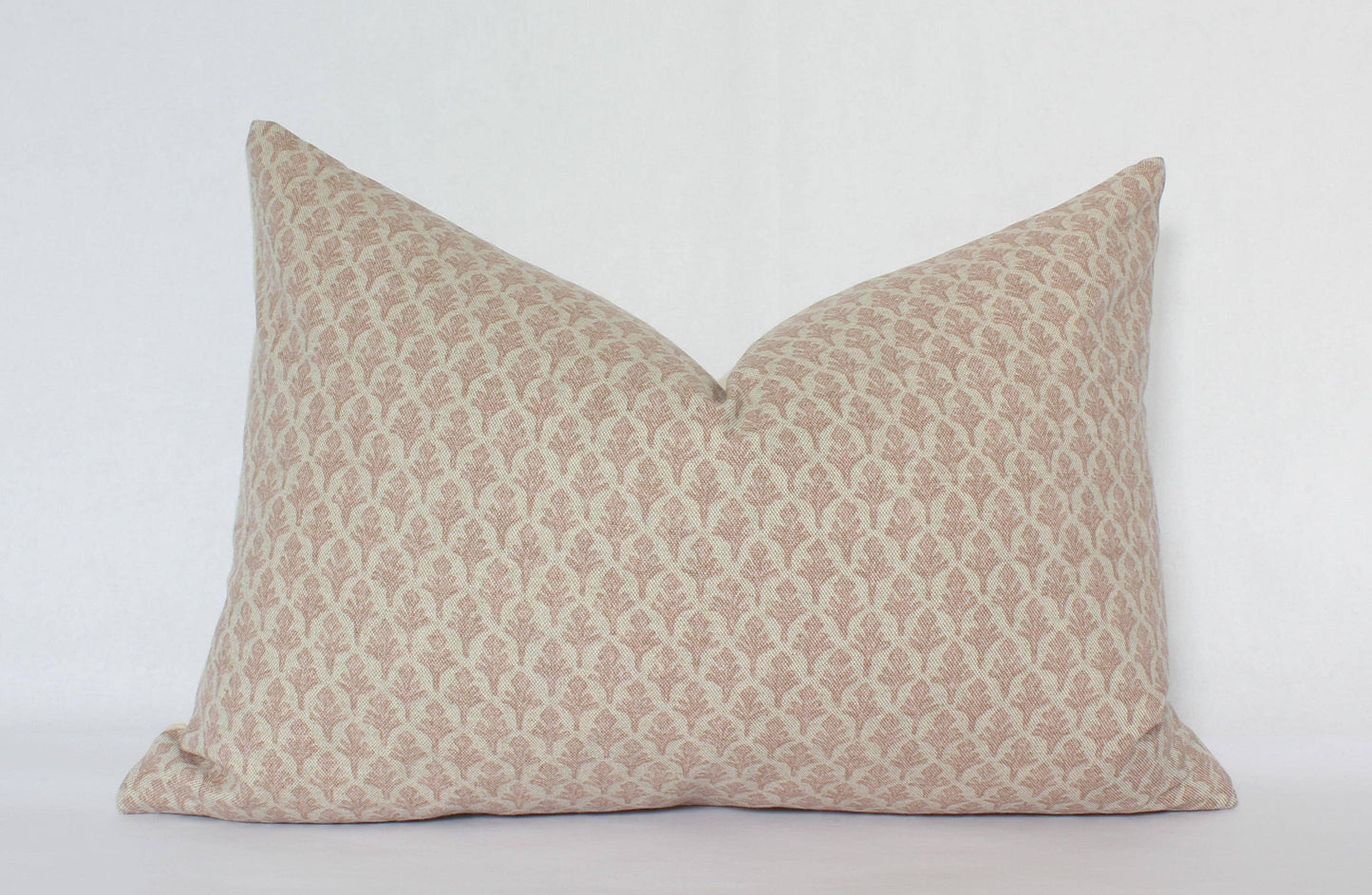 Decorative beige patterned lumbar pillow on white background. Come see us at Awaken, Franklin, Tennessee