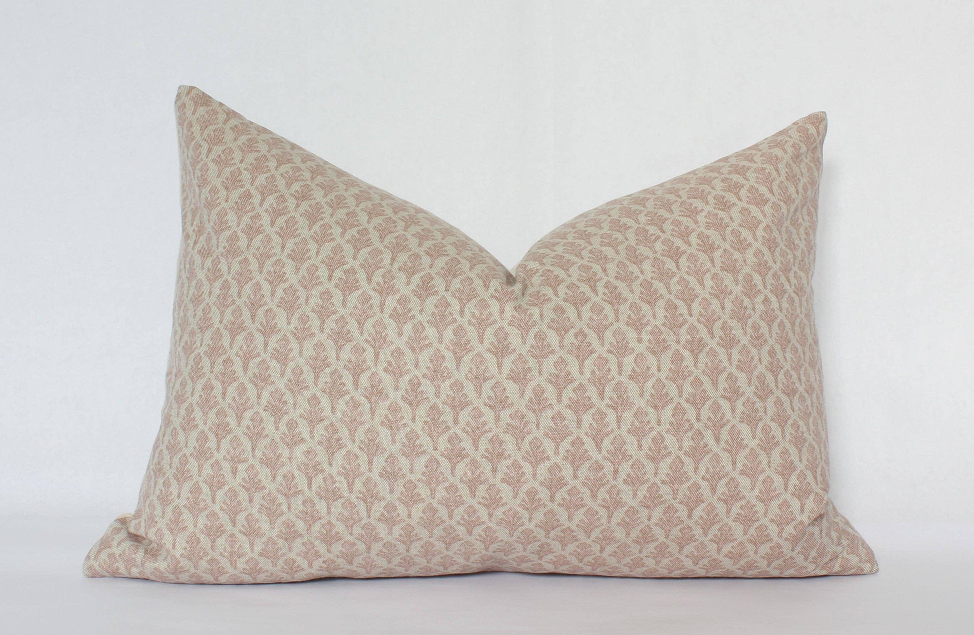 Decorative beige patterned lumbar pillow on white background. Come see us at Awaken, Franklin, Tennessee