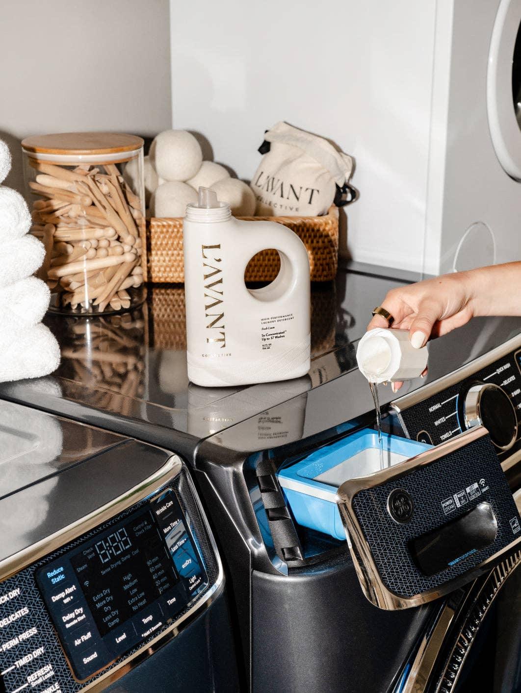 L'AVANT laundry detergent poured into washing machine, modern laundry room, Come see us at Awaken, Franklin, Tennessee.