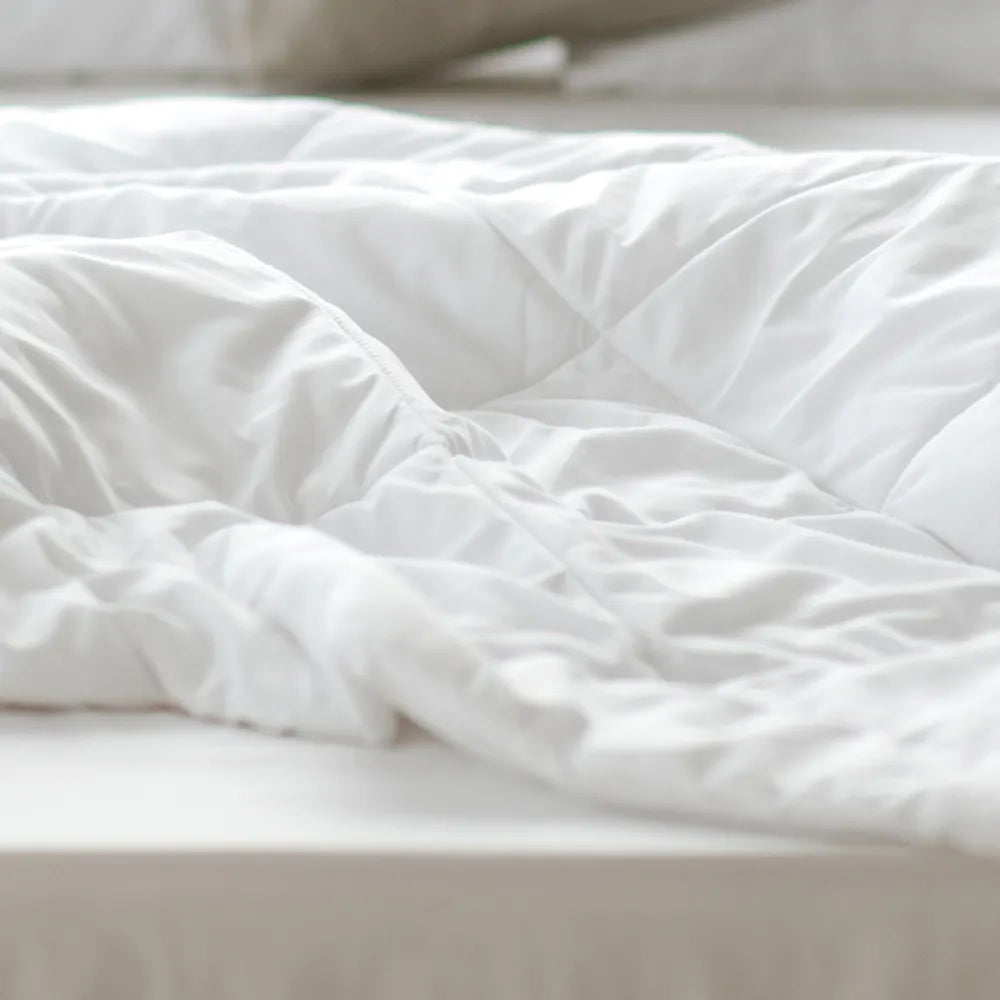 Soft white comforter on bed, cozy bedding, Come see us at Awaken, Franklin, Tennessee